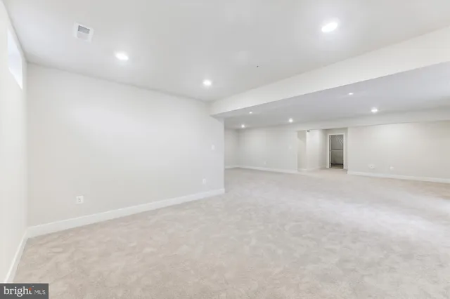 an empty room with a empty space and windows