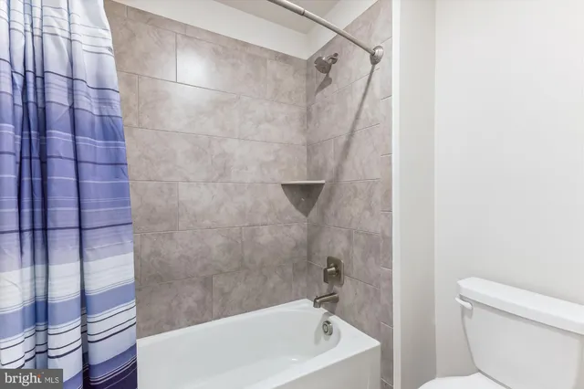 a bathroom with a bathtub and toilet