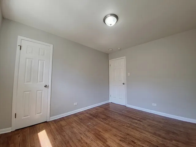 a view of an empty room and wooden floor