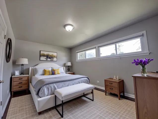a bedroom with a bed and a potted plant