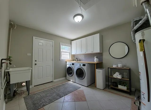 a utility room with sink dryer and washer