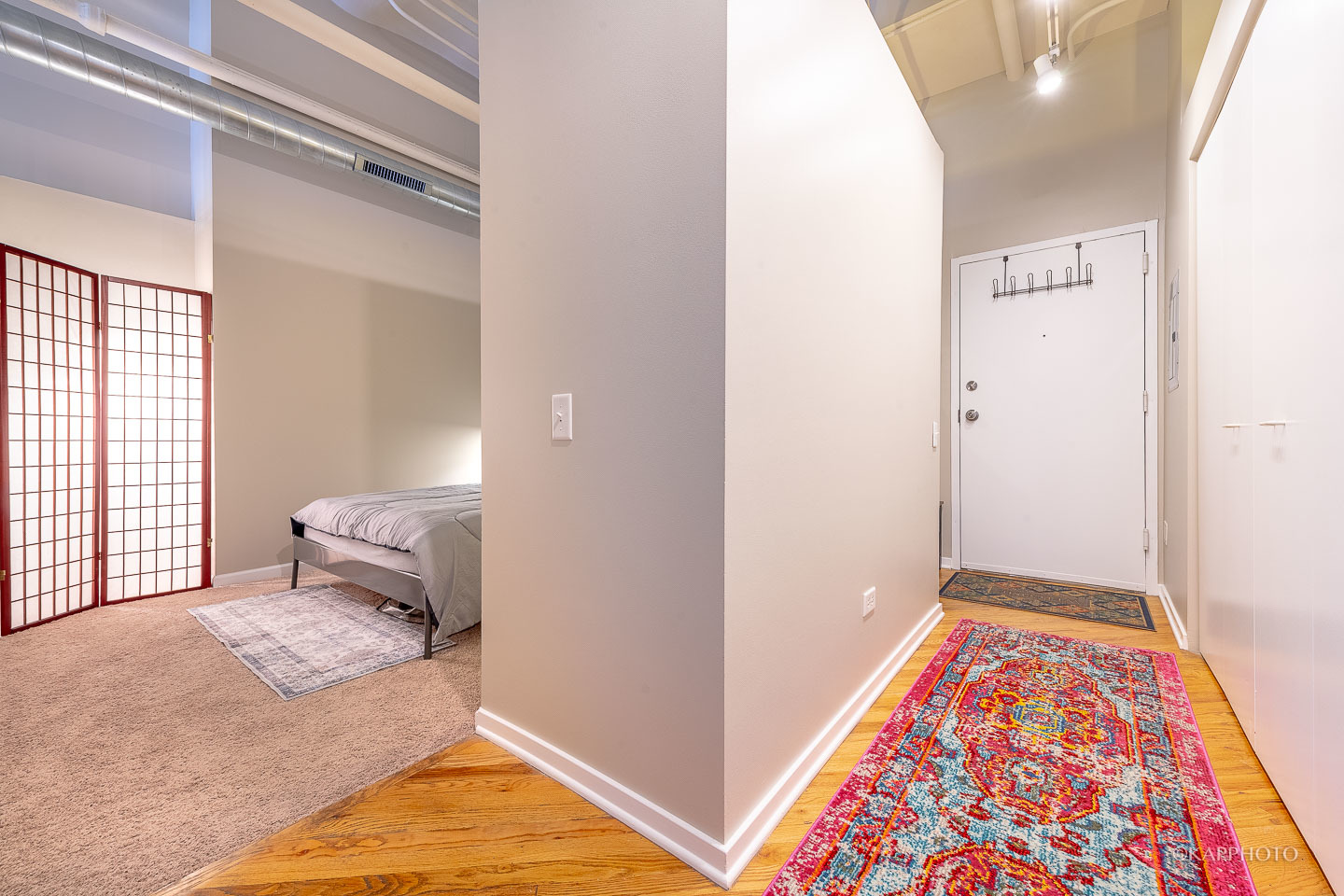 500 South Clinton Street, Unit 133 Chicago, IL 60607 - Photo 15 of 28 a bedroom with a bed and wooden floor
