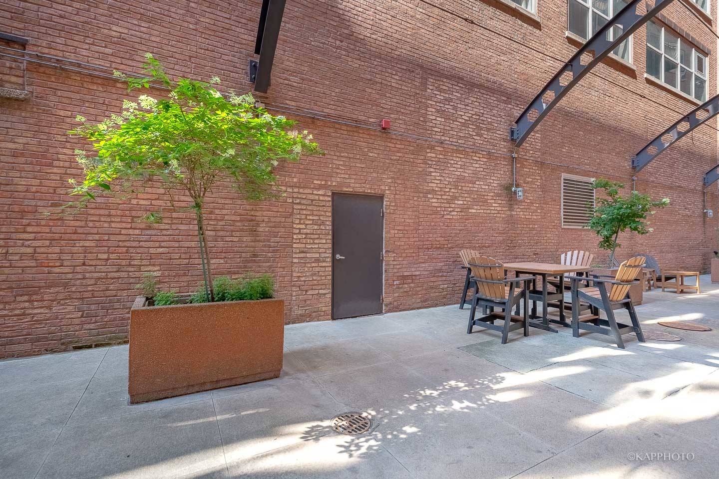 500 South Clinton Street, Unit 133 Chicago, IL 60607 - Photo 27 of 28 a view of a patio with table and chairs and potted plants