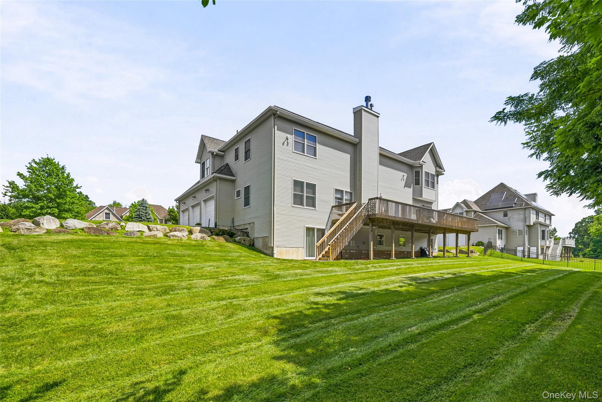 51 Meriwether Trail Congers, NY 10920 - Photo 45 of 50 Expansive green lawn featuring a raised wood deck with staircase access
