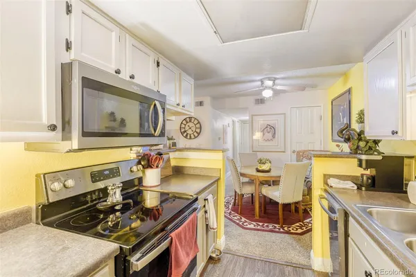 a kitchen with stainless steel appliances granite countertop a sink stove and cabinets