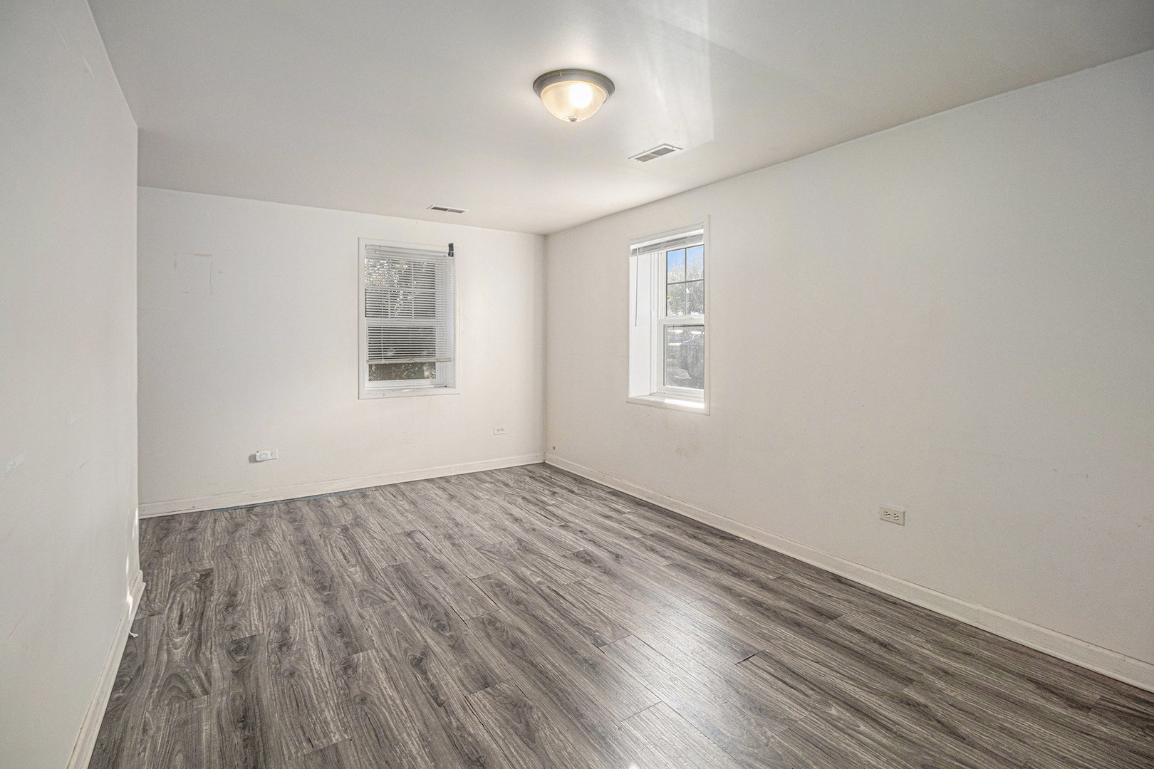 2036 Thornton Lansing Road Lansing, IL 60438 - Photo 3 of 17 an empty room with wooden floor and windows