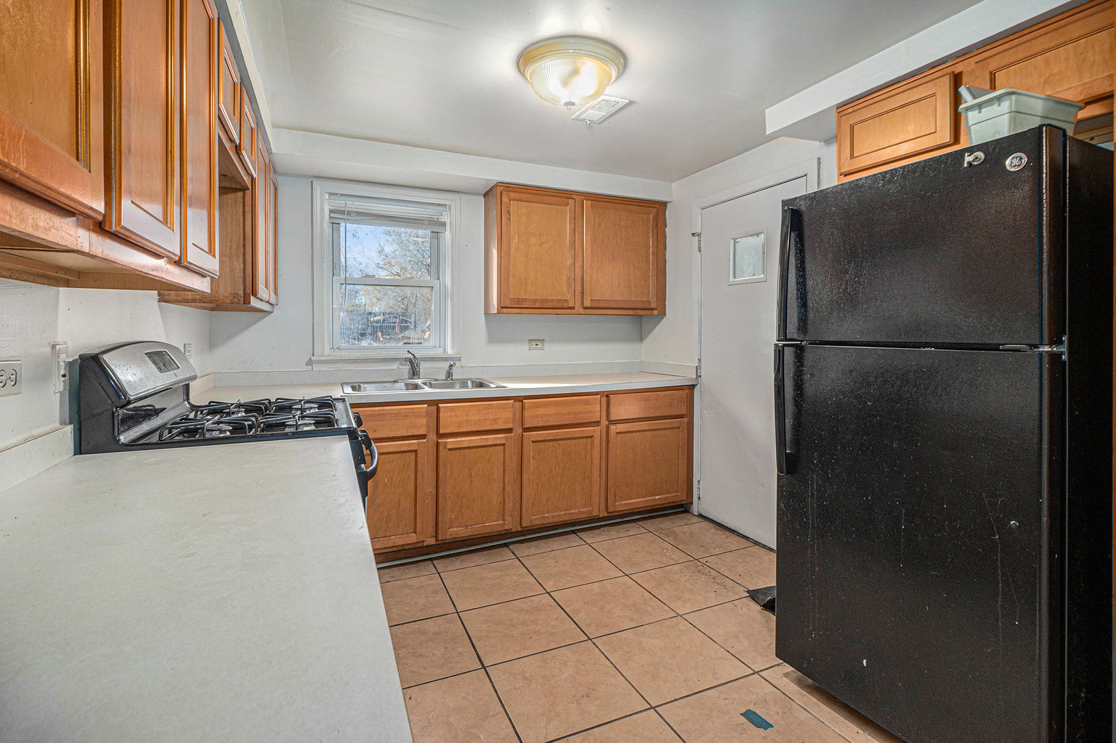 2036 Thornton Lansing Road Lansing, IL 60438 - Photo 6 of 17 a kitchen with a sink a refrigerator and cabinets