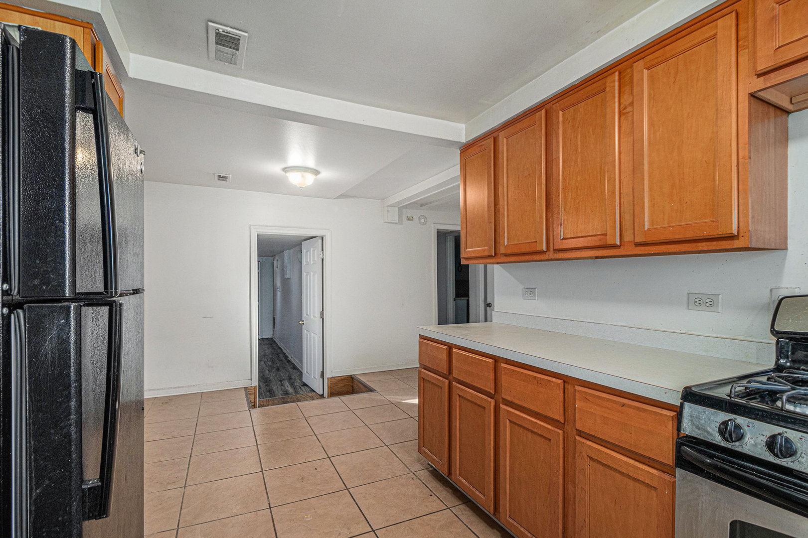 2036 Thornton Lansing Road Lansing, IL 60438 - Photo 7 of 17 a kitchen with stainless steel appliances granite countertop a refrigerator and a stove top oven