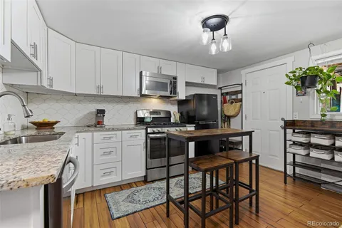 a kitchen with a stove a sink and cabinets