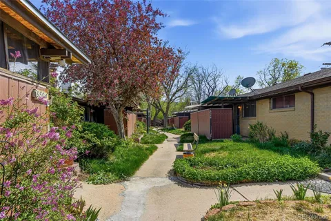 a backyard of a house with lots of green space and fountain