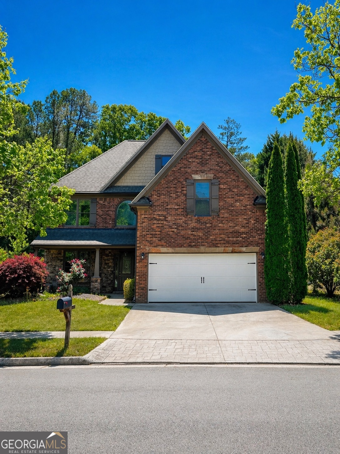 2614 Dolostone Way Dacula, GA 30019 - Photo 1 of 29 a front view of a house with a yard and potted plants