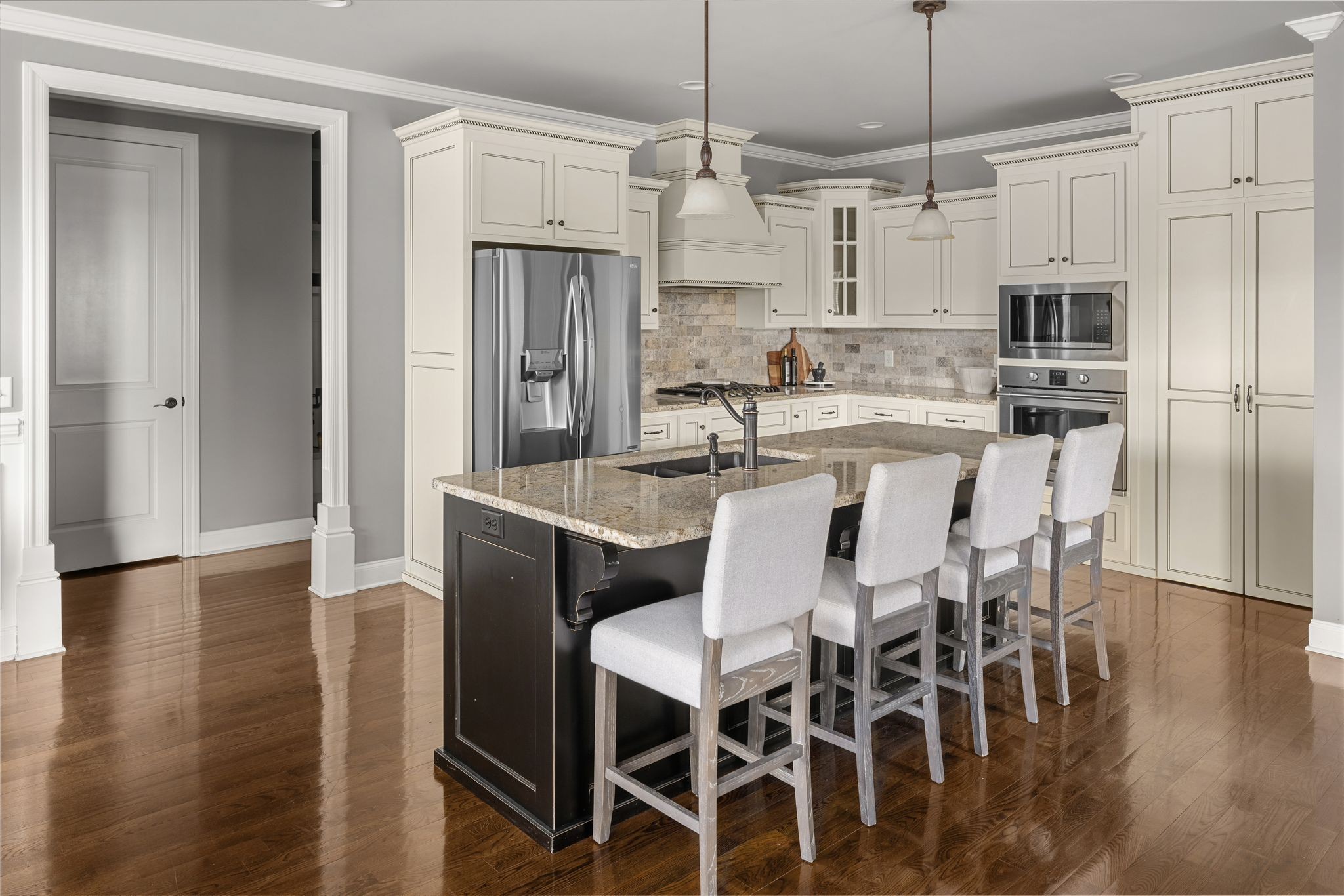 3226 Pleasantville Bridge Road Thompson's Station, TN 37179 - Photo 17 of 59 a kitchen with stainless steel appliances kitchen island granite countertop a dining table chairs refrigerator and sink