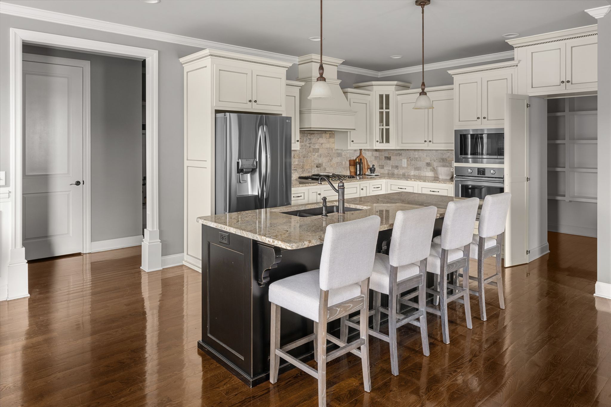 3226 Pleasantville Bridge Road Thompson's Station, TN 37179 - Photo 18 of 59 a kitchen with stainless steel appliances kitchen island granite countertop a refrigerator and microwave