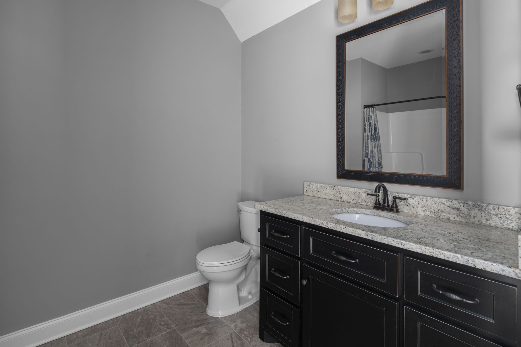 3226 Pleasantville Bridge Road Thompson's Station, TN 37179 - Photo 47 of 59 a bathroom with a granite countertop toilet sink and mirror