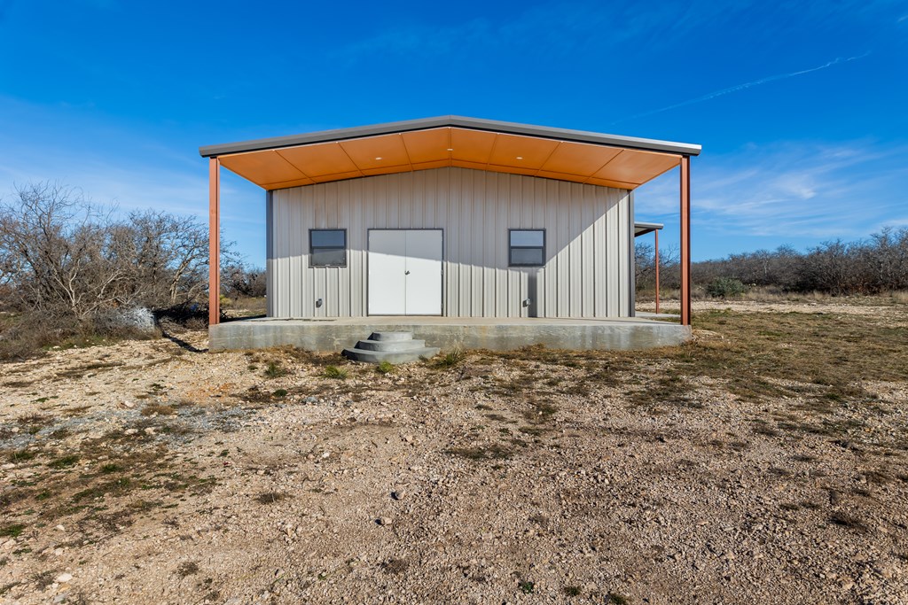 497 County Road Melvin, TX 76858 - Photo 14 of 44 a front view of a house with a yard