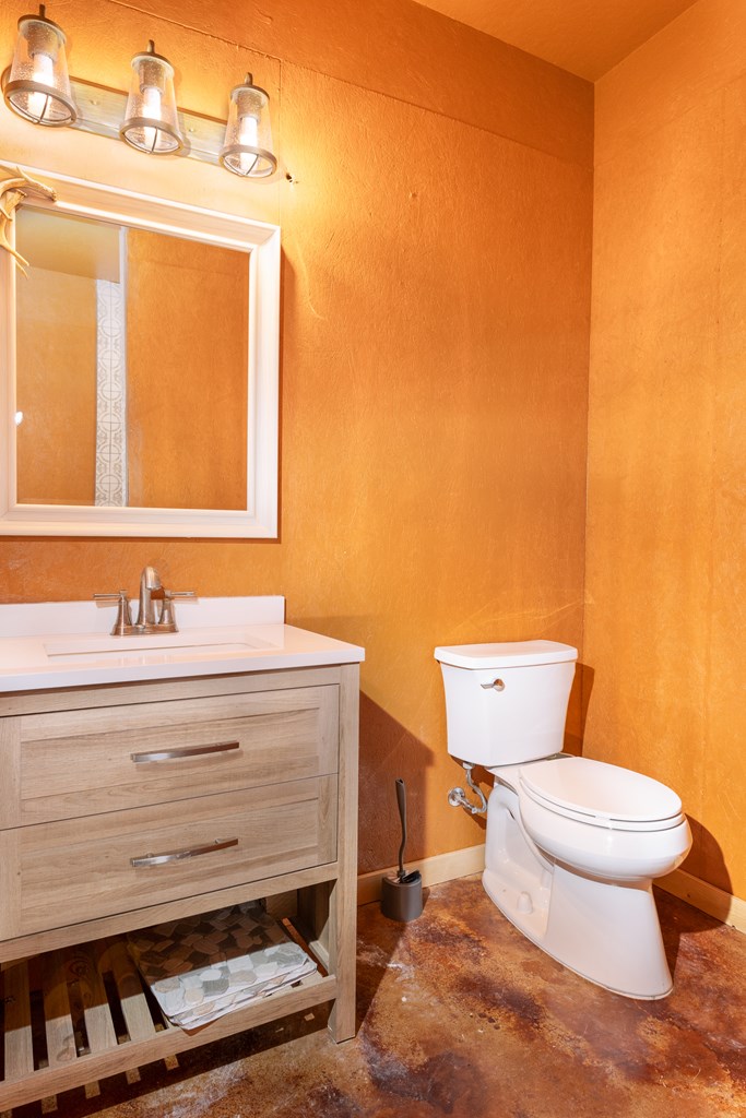 497 County Road Melvin, TX 76858 - Photo 8 of 44 a bathroom with a toilet and a sink
