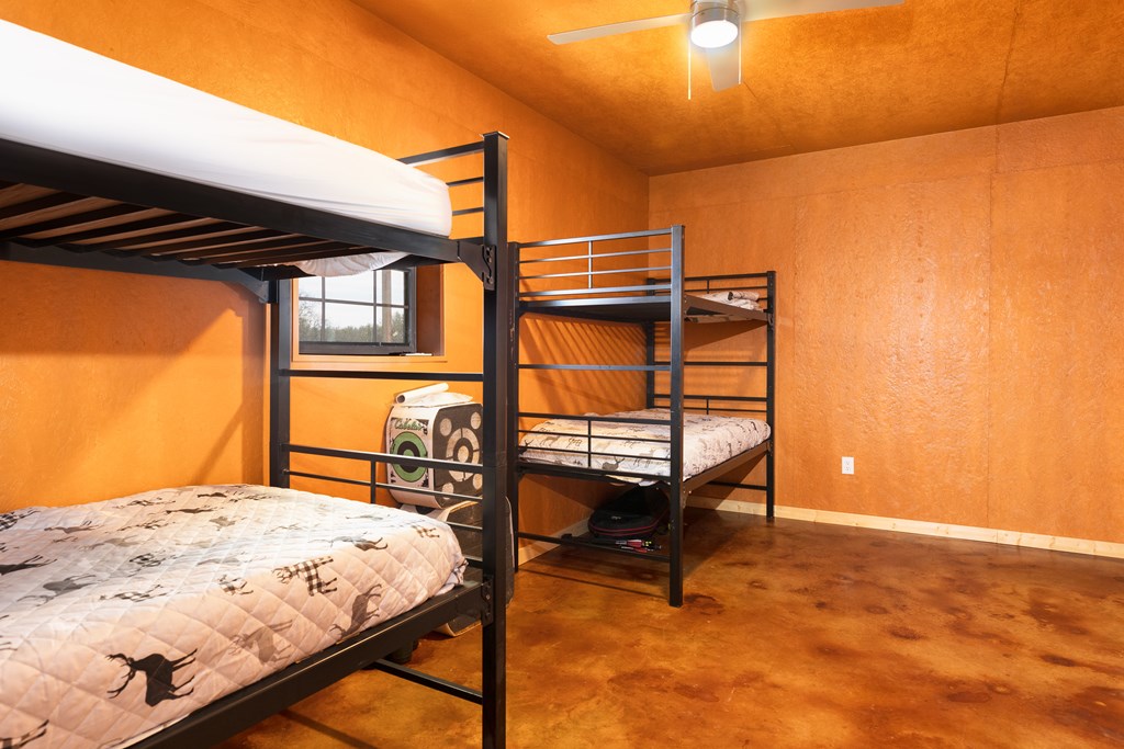 497 County Road Melvin, TX 76858 - Photo 10 of 44 a bedroom with a bed and paintings on the wall