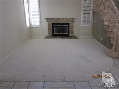 3904 Sunsetridge Road Moorpark, CA 93021 - Photo 4 of 8 a view of an empty room with a fireplace and a window