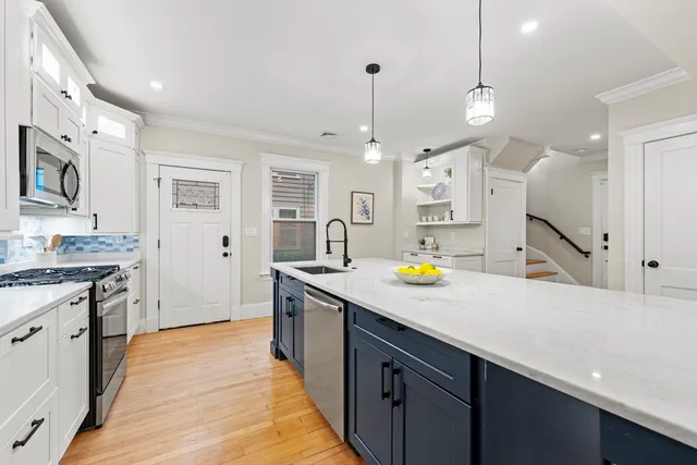 a kitchen with stainless steel appliances a stove sink and refrigerator