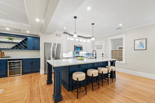 a large kitchen with a table and chairs