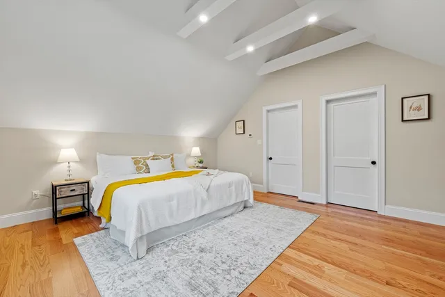 a spacious bedroom with a bed and a dresser