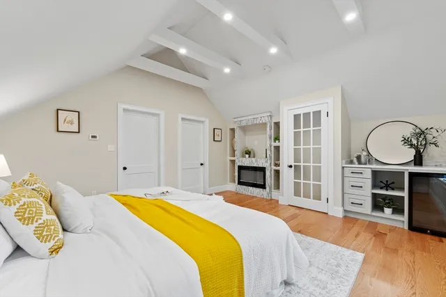 a spacious bedroom with a bed and a dresser