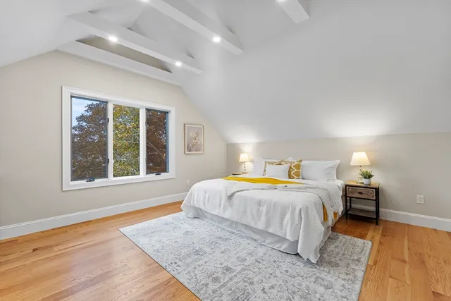 a white bath tub sitting next to a white toilet and a shower