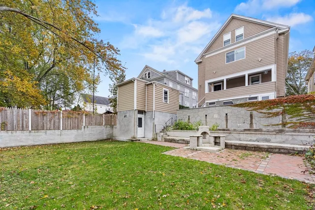a view of a patio with table and chairs and potted plants with wooden floor and fence