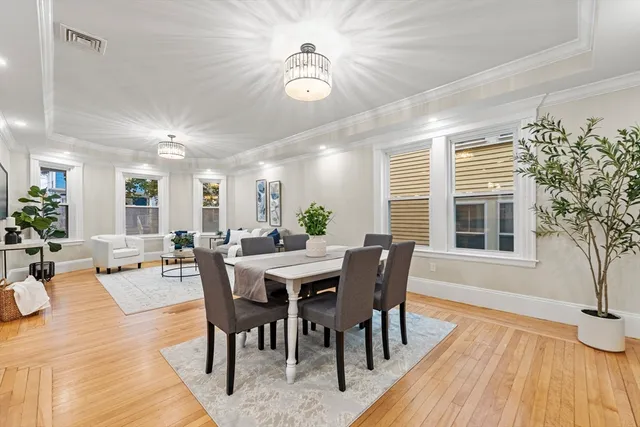 a view of a dining room with furniture window and wooden floor
