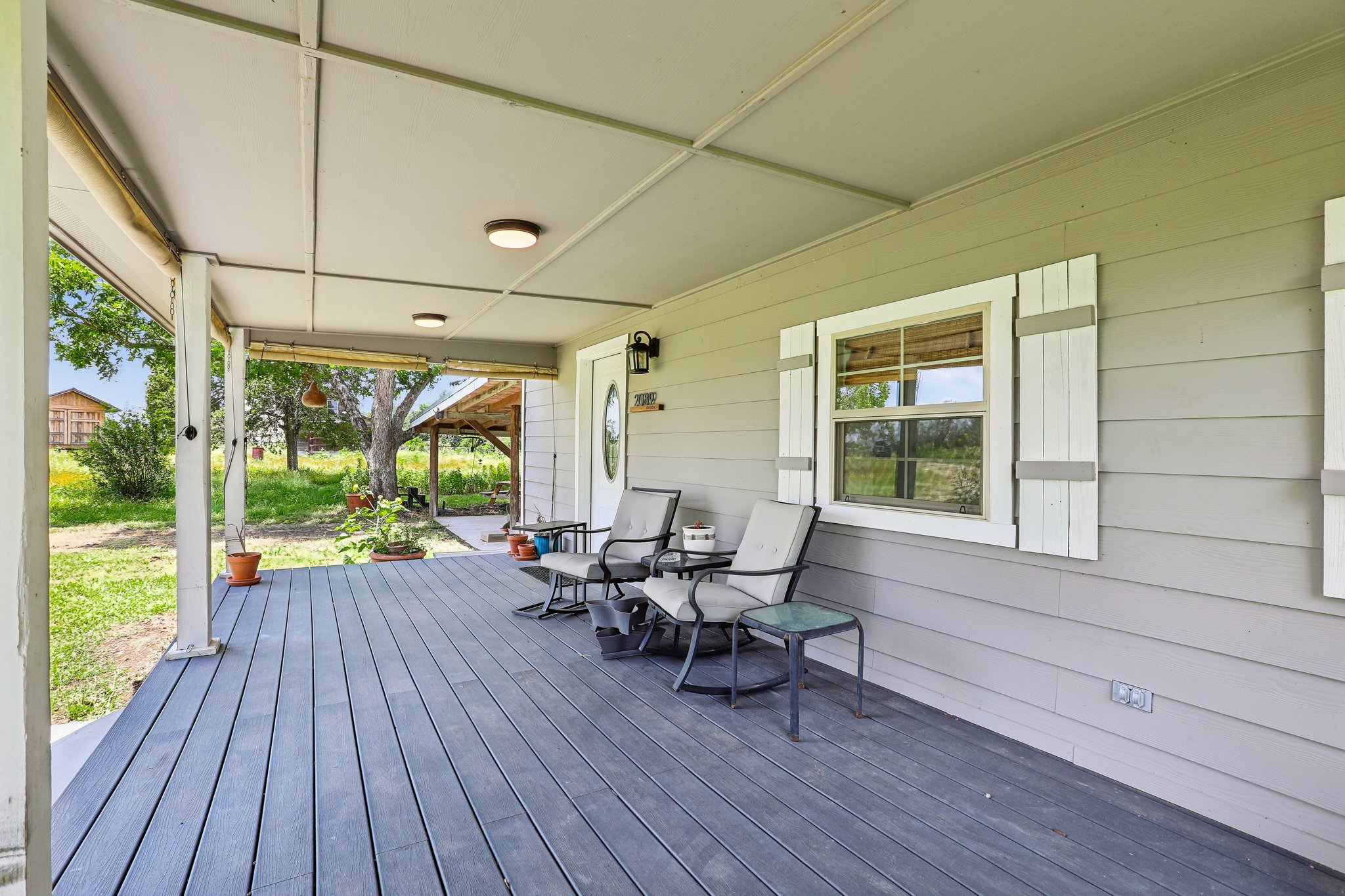 2089 Farm To Market Road 1704 Elgin, TX 78621 - Photo 4 of 31 An inviting covered porch extends a warm welcome, offering serene outdoor moments.