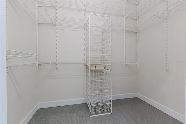 a view of walk in closet with empty racks