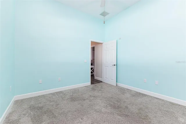 an empty room with a empty space and a ceiling fan