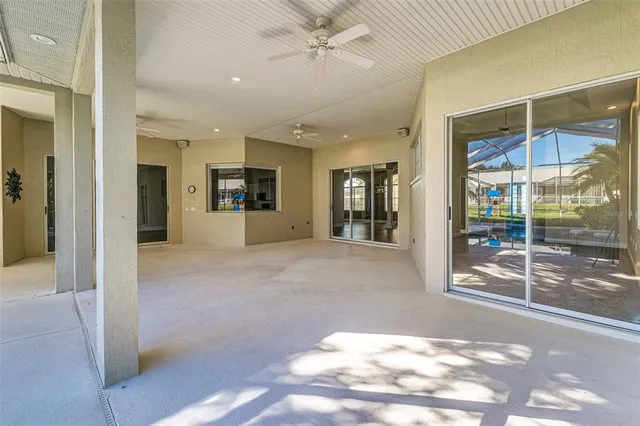 a view of a hallway with wooden floor and a glass door