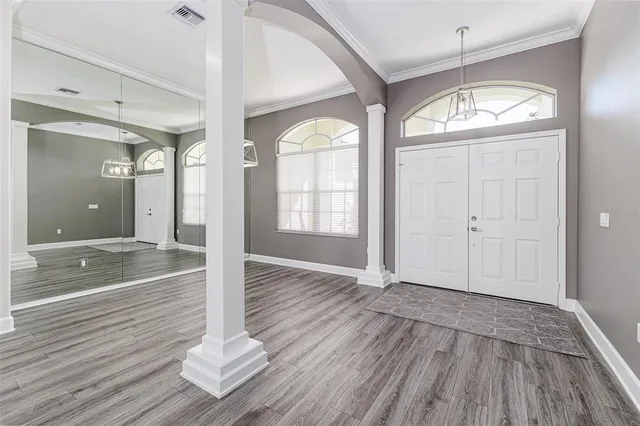 wooden floor in an empty room with a window