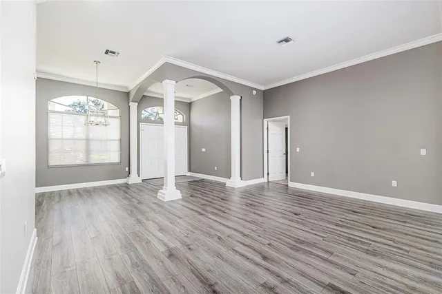 wooden floor in an empty room with a window