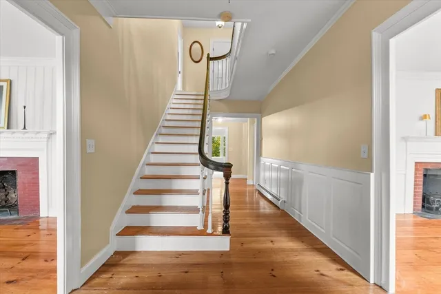 a view of entryway and hall with wooden floor