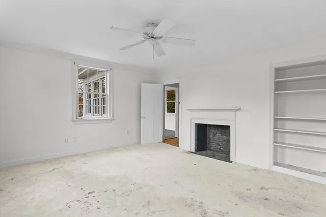 a view of empty room with a fireplace