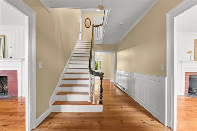 a view of entryway and hall with wooden floor