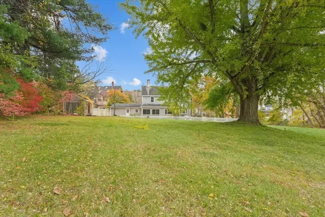 a view of a house with backyard sitting area and garden