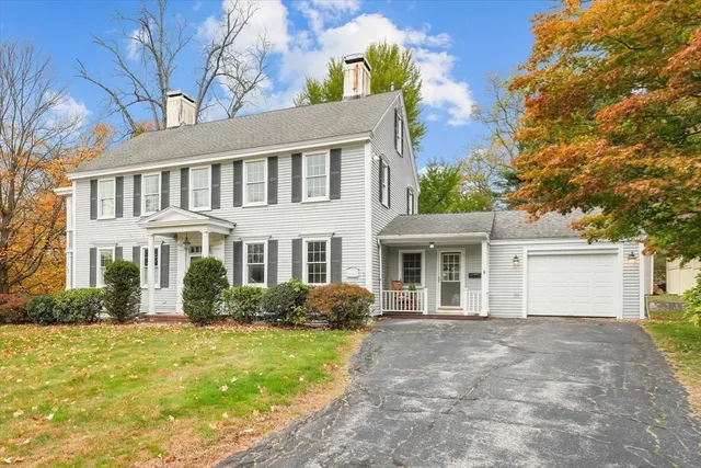 aerial view of residential houses with yard and mountain view in back