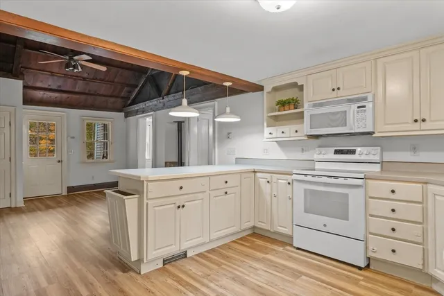 a kitchen with stainless steel appliances granite countertop a stove and white cabinets