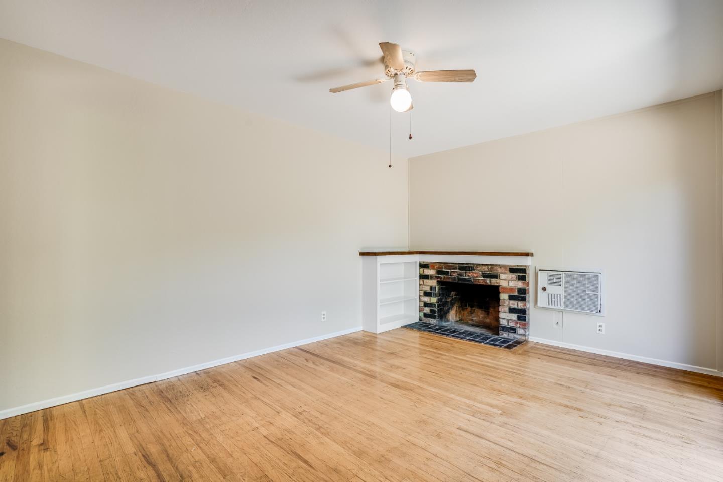 4559 Piper Drive San Jose, CA 95129 - Photo 13 of 30 an empty room with a fireplace and painted walls