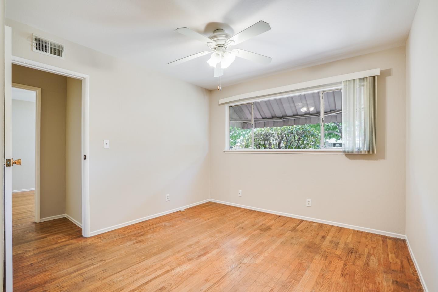 4559 Piper Drive San Jose, CA 95129 - Photo 20 of 30 a view of an empty room with wooden floor and a window