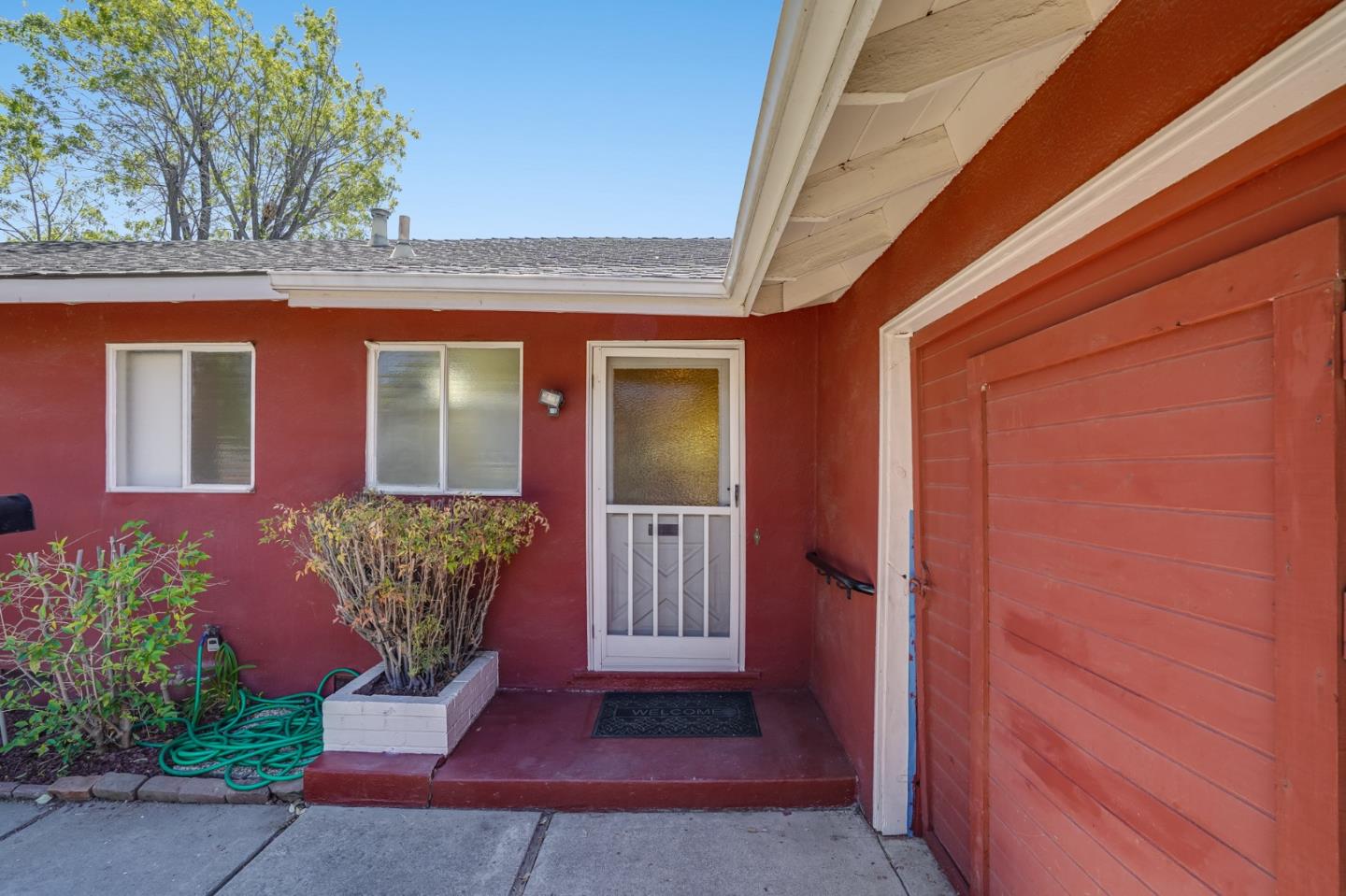 4559 Piper Drive San Jose, CA 95129 - Photo 3 of 30 a front view of a house with a glass door and potted plants