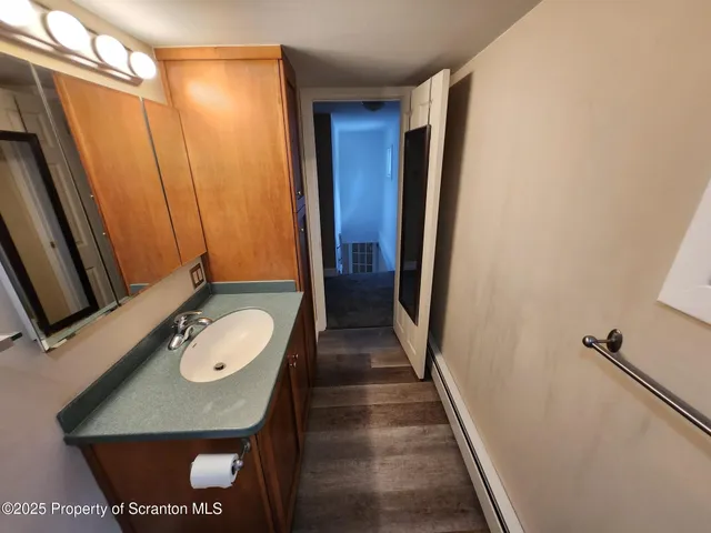 a bathroom with a granite countertop sink and a mirror