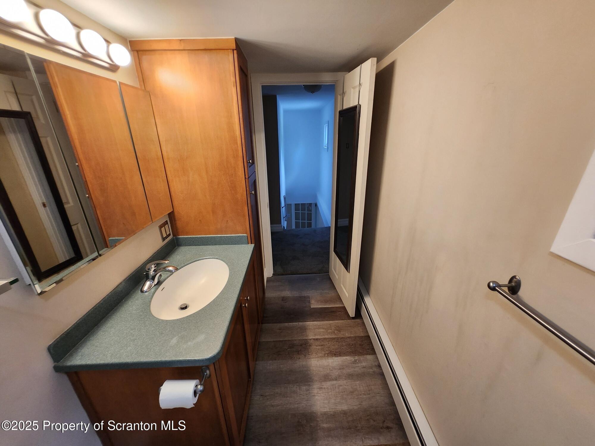 16 Flanagan Street Pringle, PA 18704 - Photo 20 of 33 a bathroom with a granite countertop sink and a mirror