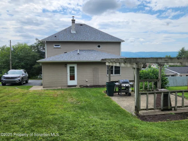 a front view of a house with a garden and yard