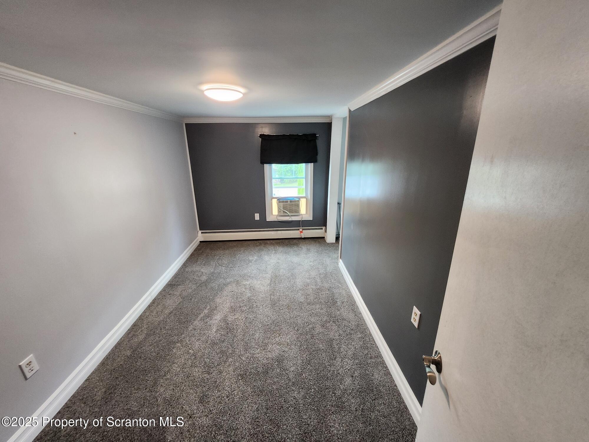 16 Flanagan Street Pringle, PA 18704 - Photo 21 of 33 wooden floor in an empty room with a window