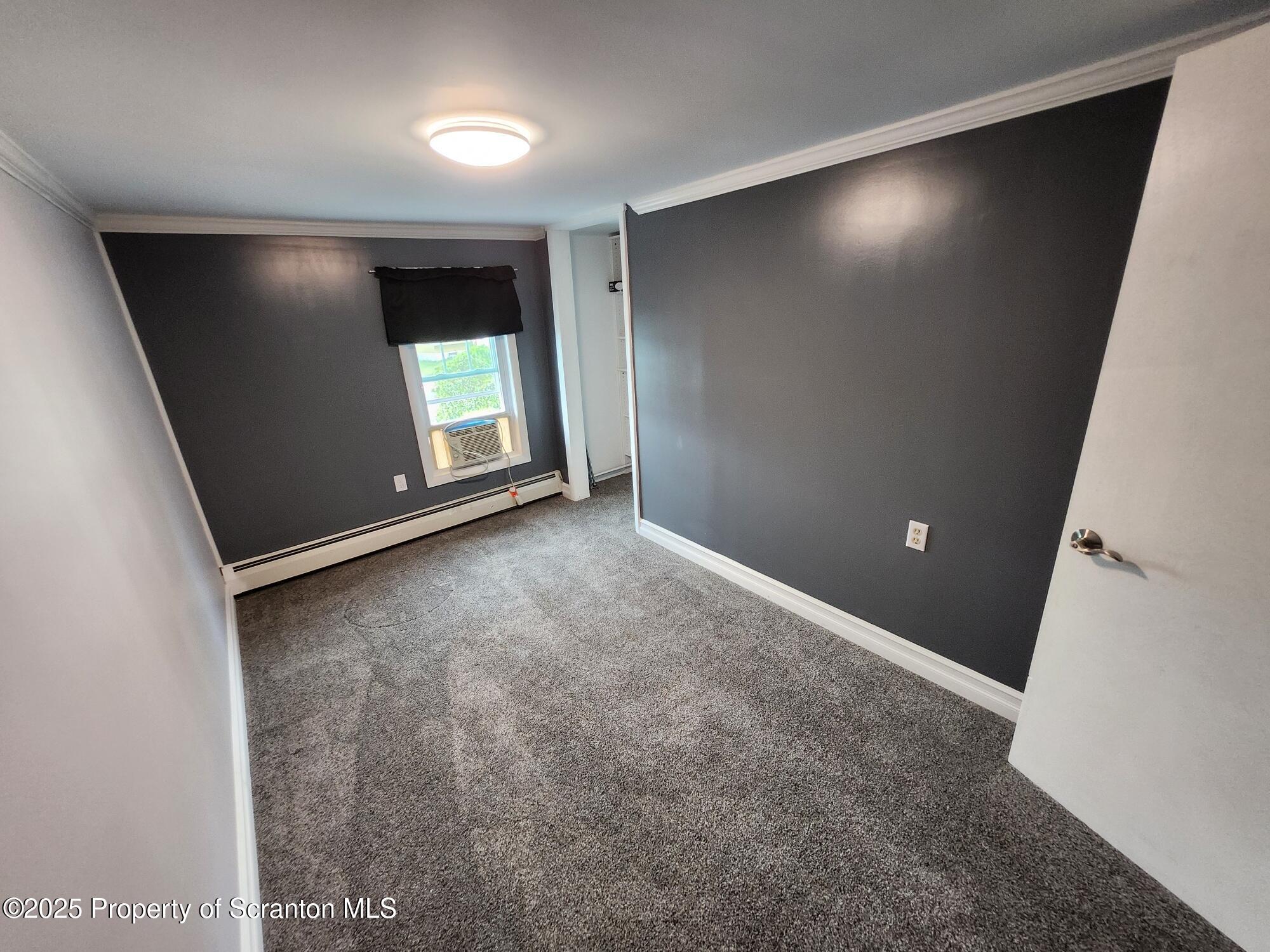 16 Flanagan Street Pringle, PA 18704 - Photo 23 of 33 an empty room with windows and mirror