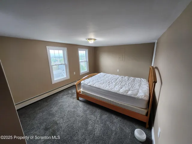 a bed sitting in a room next to a window
